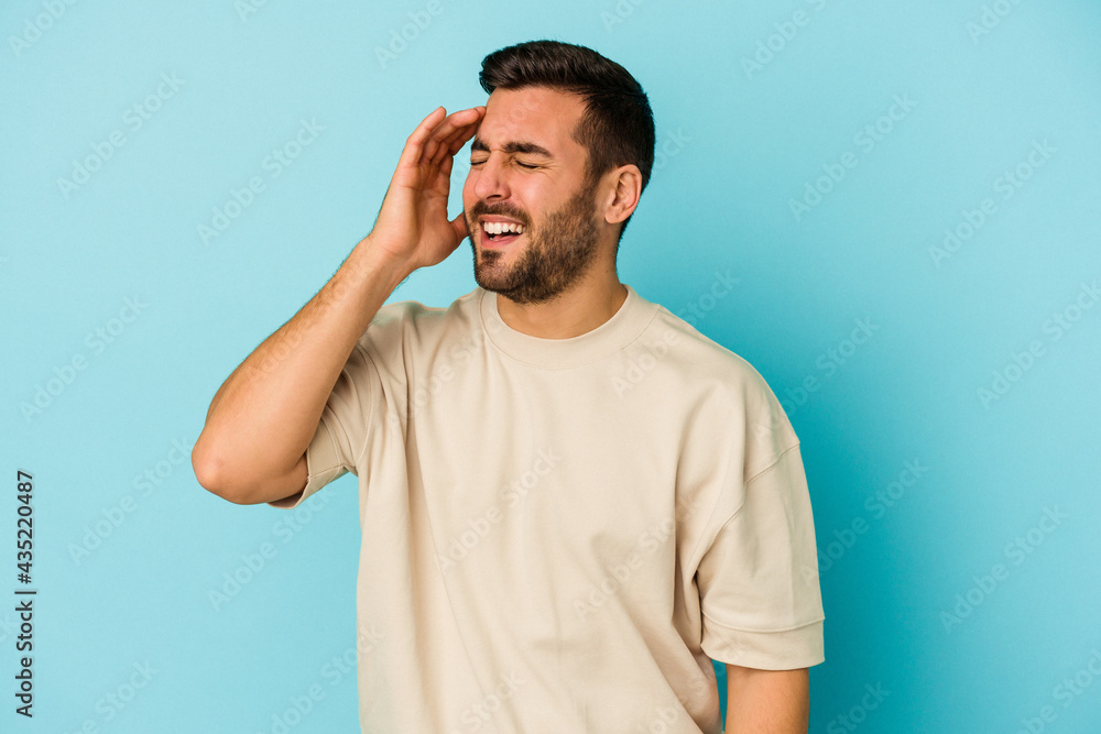 Young caucasian man isolated on blue background joyful laughing a lot. Happiness concept. Young caucasian man isolated on blue background joyful laughing a lot. Happiness concept.