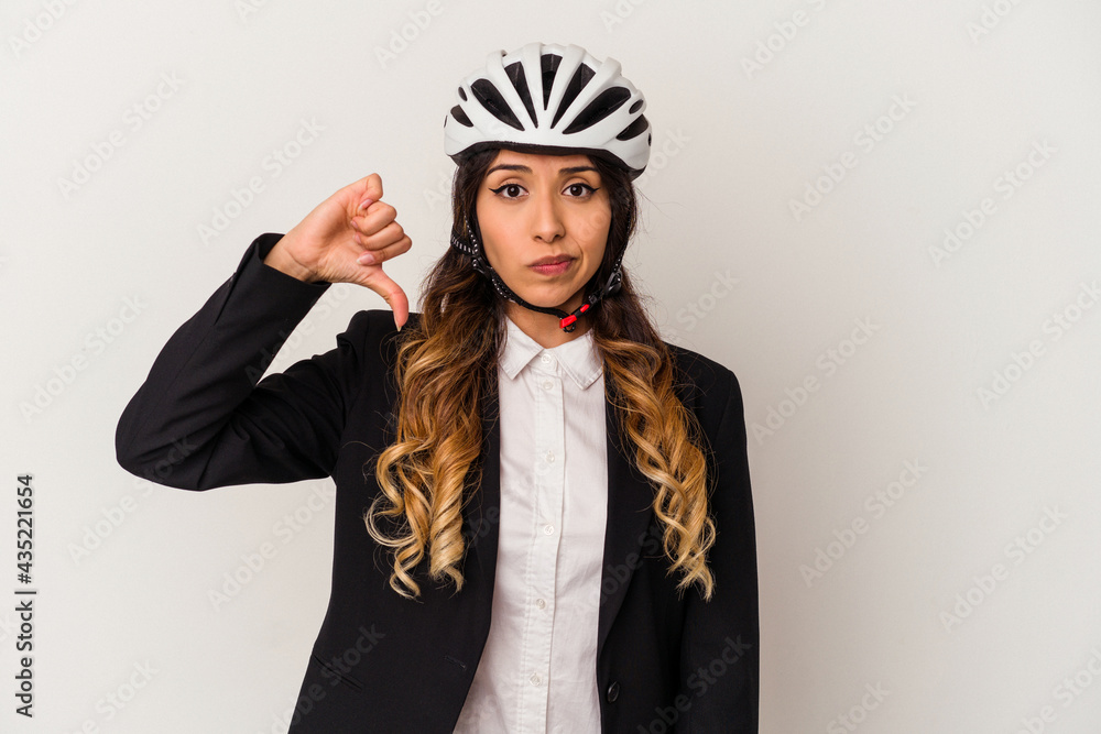 Young mexican woman riding a bicycle to work isolated on white background showing a dislike gesture, thumbs down. Disagreement concept. Young mexican woman riding a bicycle to work isolated on white background showing a dislike gesture, thumbs down. Disagreement concept.