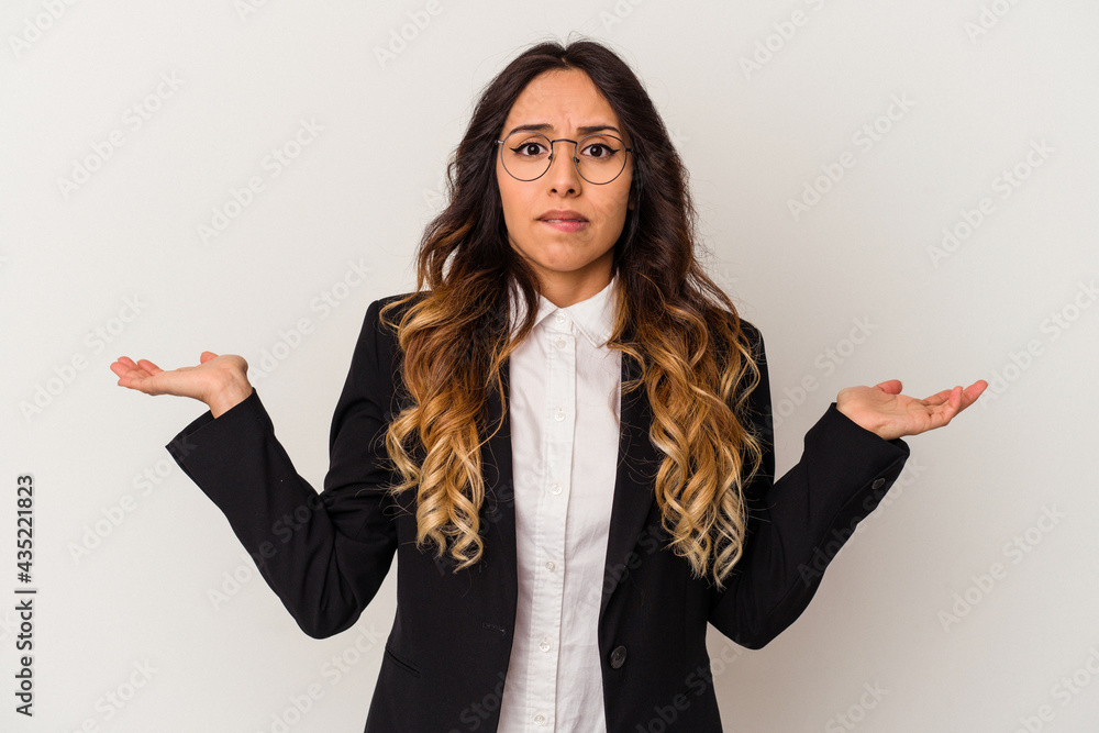Young mexican business woman isolated on white background confused and doubtful shrugging shoulders to hold a copy space. Young mexican business woman isolated on white background confused and doubtful shrugging shoulders to hold a copy space.