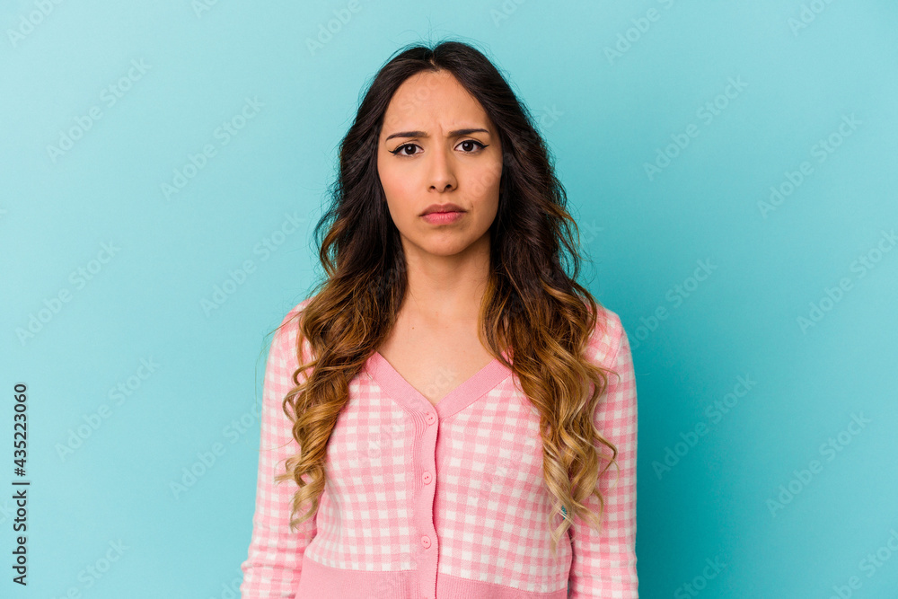 Fototapeta premium Young mexican woman isolated on blue background sad, serious face, feeling miserable and displeased.
