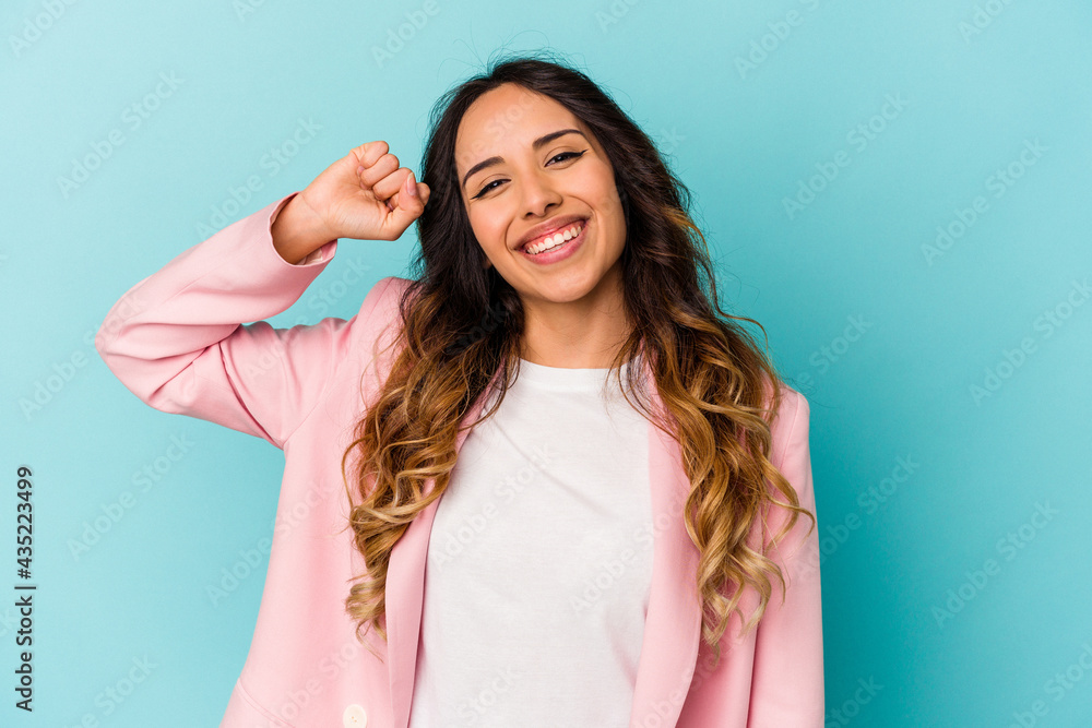 Young mexican woman isolated on blue background celebrating a victory, passion and enthusiasm, happy expression. Young mexican woman isolated on blue background celebrating a victory, passion and enthusiasm, happy expression.
