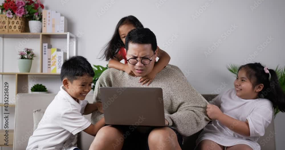 Father trying use laptop to work and disturbed by children. Father trying use laptop to work and disturbed by children.
