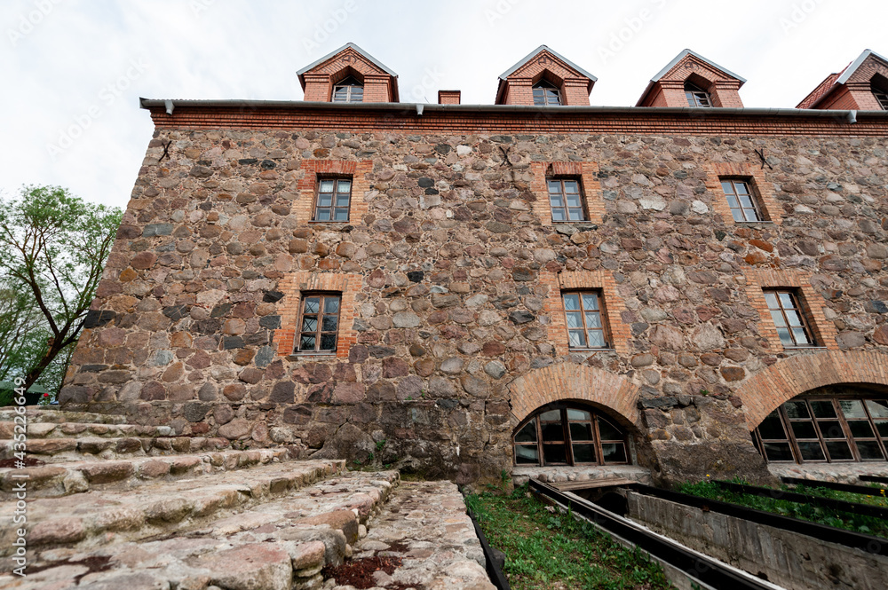Fototapeta premium An old mill of the 19th century with a restoration in the village of Dvorishche