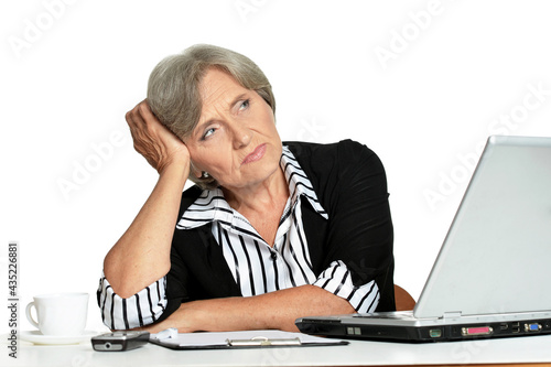 elderly woman working with laptop on white background
