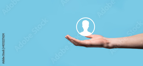 Hand holds user person icon interface on blue background.User symbol for your web site design, logo, app, UI.Banner