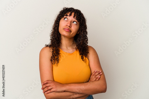 Young mixed race woman isolated on white background tired of a repetitive task.