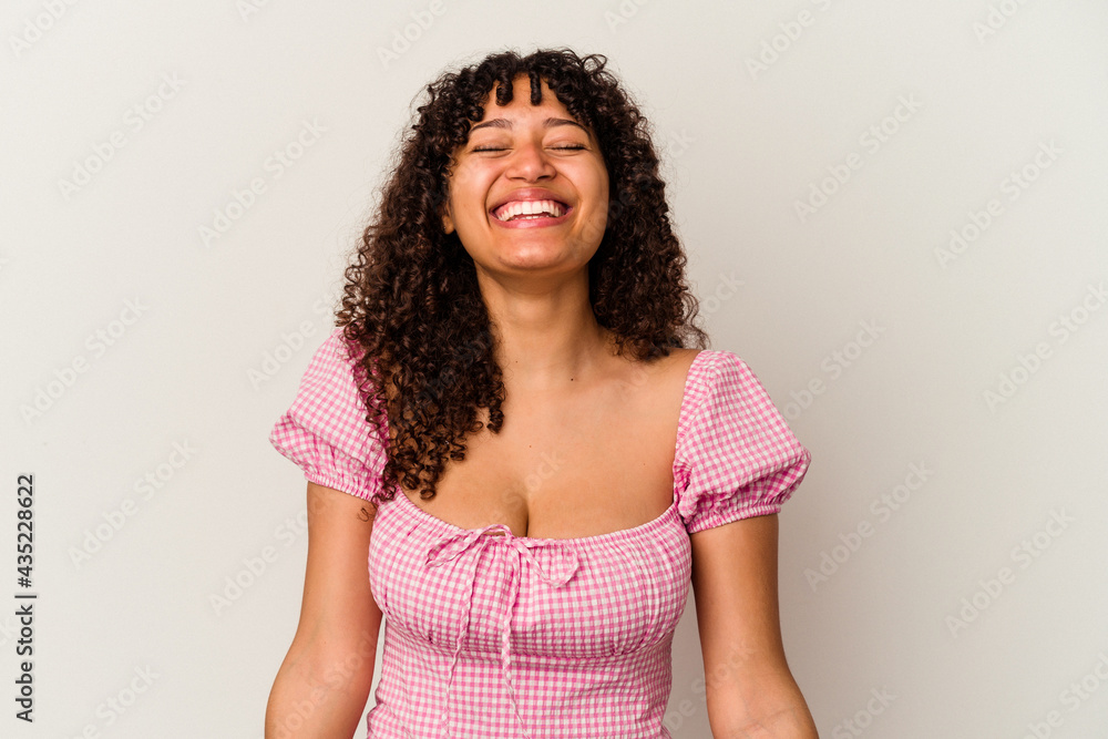 Young mixed race woman isolated on white background laughs and closes eyes, feels relaxed and happy. Young mixed race woman isolated on white background laughs and closes eyes, feels relaxed and happy.