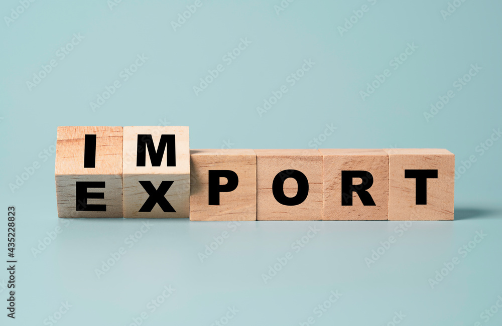 Flipping of wooden between import and export on blue background , Business investment concept. Flipping of wooden between import and export on blue background , Business investment concept.