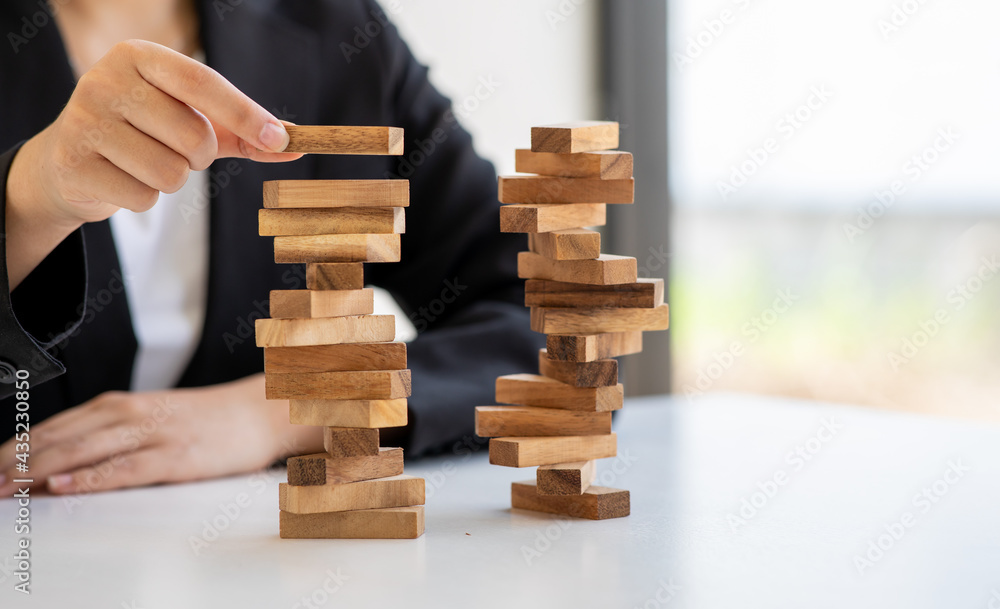 Abstract business women fail danger tower block game building construction protect plan and project control.strategy and successful intervention concept for business. Abstract business women fail danger tower block game building construction protect plan and project control.strategy and successful intervention concept for business.
