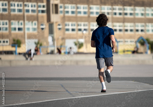 sportsman running on the street © pintoreduardo