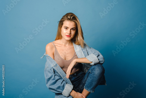 Casual beauty concept of pretty young woman on blue background