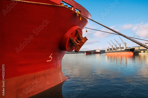 The bow of an industrial ship at the mooring wall in the seaport