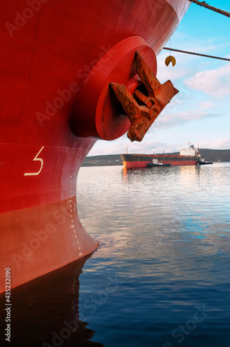 The bow of an industrial ship at the mooring wall in the seaport