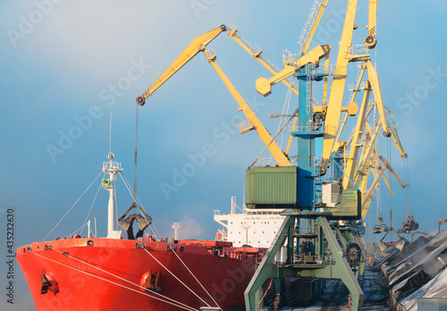 huge amount of coal in the Murmansk commercial seaport. Coal is delivered here in industrial wagons, distributed throughout the port, unloaded, and then loaded onto sea dry cargo ships.
