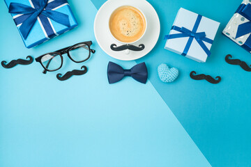 Happy Fathers day concept with coffee cup,  tie bow and gift box on blue background