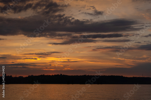 beautiful sunset over the river with orange colors © DMYTRO