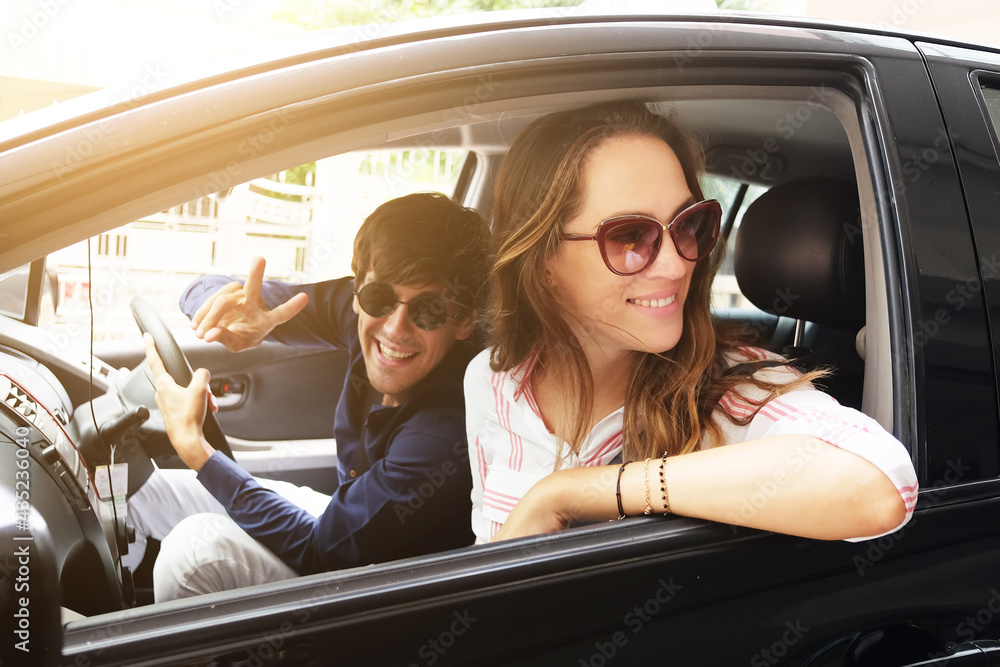 Smiling Young Caucasian traveler couple love is relaxing and Driving a car for travel on holiday. Happiness of Honeymoon trip on vacation concept.