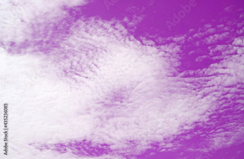 Pop art surreal style white cloud on vivid purple colored sky for abstract background