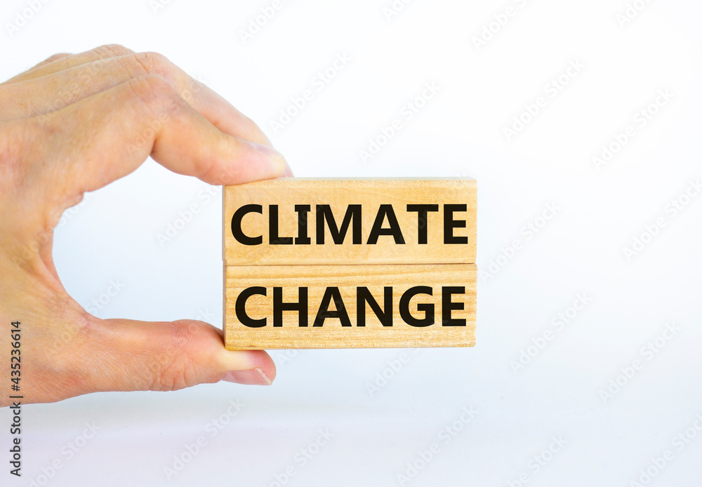 Climate change symbol. Wooden blocks with words 'Climate change' on beautiful white background. Businessman hand. Business, ecological and climate change concept. Copy space. Climate change symbol. Wooden blocks with words 'Climate change' on beautiful white background. Businessman hand. Business, ecological and climate change concept. Copy space.