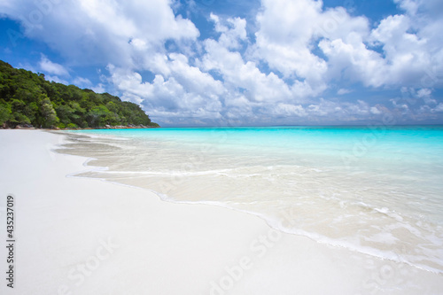 Travel vacation background concept at summer beach with the sunny sky at Phuket island, Thailand. Beautiful scene of blue sky and clouds on a sunny day. Empty holiday sea where horizon can see clearly