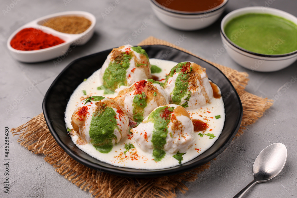 Indian street food Dahi vada Dahi Bhalla with green chutney, tamarind