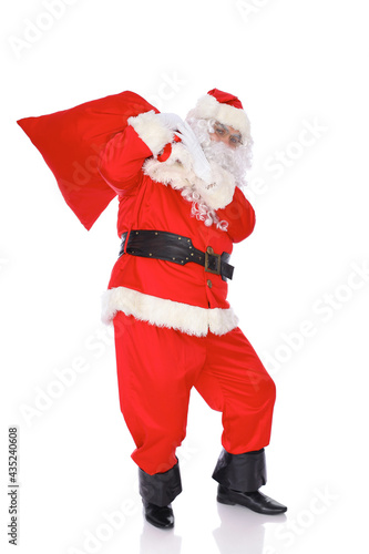 Santa Claus carrying big bag. Isolated on white background. Full length portrait