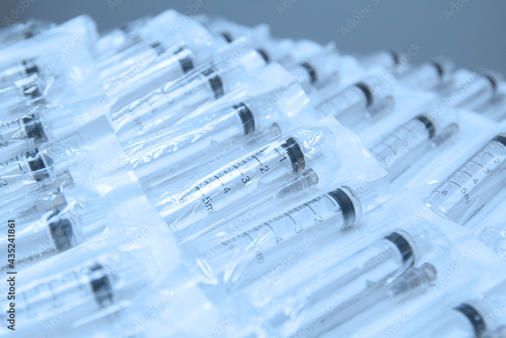 Medical syringes in a package. A bunch of unused, packaged syringes