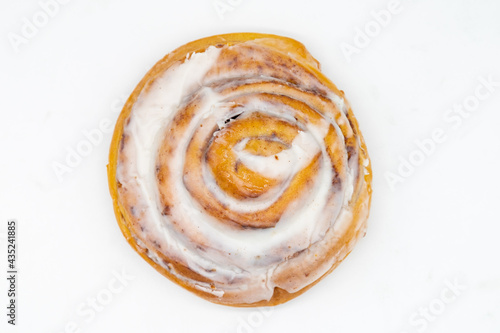 An Above View of a Delicious Homemade Cinnamon Roll Spiral with a White Background
