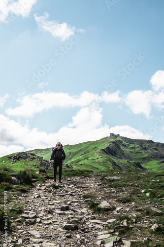 young hiker man in mountains. summer trekking path