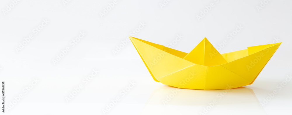 Yellow Paper boat isolated on white background with copy space, banner Yellow Paper boat isolated on white background with copy space, banner