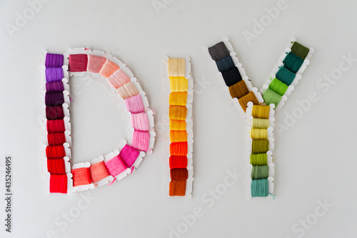 Obraz na płótnie Word DIY world made of colorful bobbins, treads. Do it yourself concept. Sewing, hobby w salonie