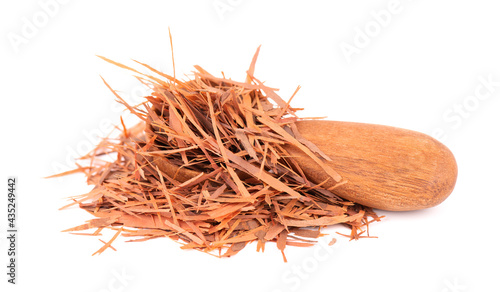 Lapacho herbal tea in wooden spoon, isolated on white background. Natural Taheeboo dry tea. Pau d'arco herb. Tabebuia heptophylla. photo