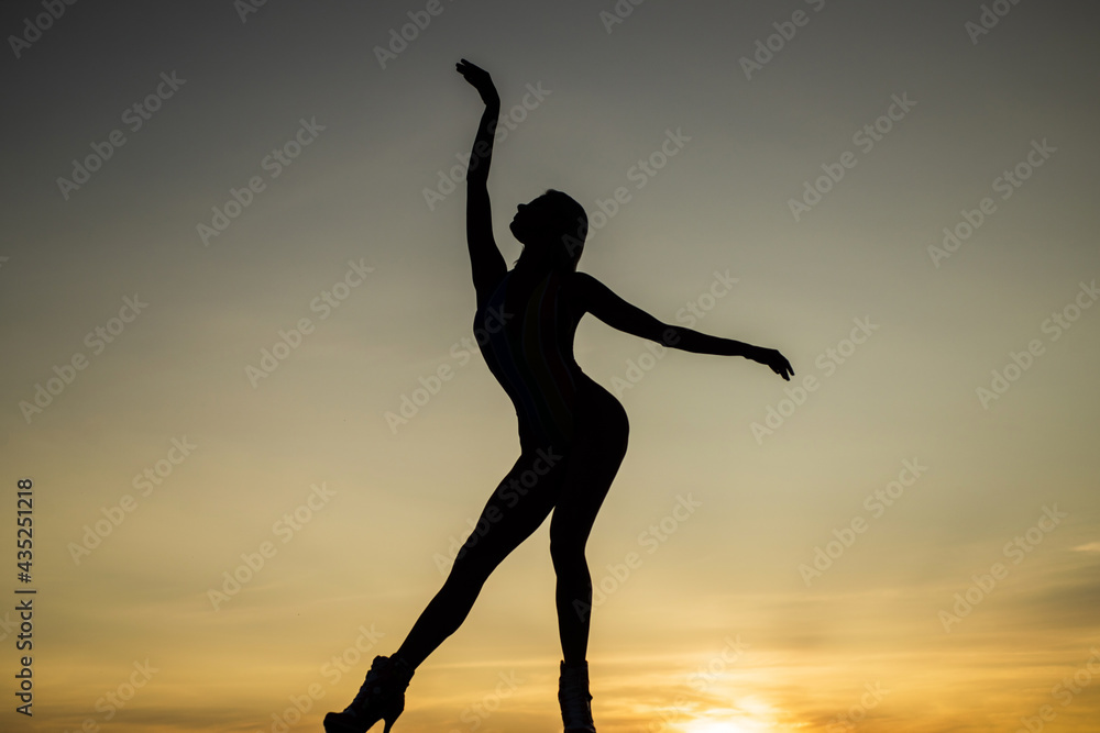 Set yourself free. Girl silhouette on evening sky. Free dance. My choice is freedom Set yourself free. Girl silhouette on evening sky. Free dance. My choice is freedom
