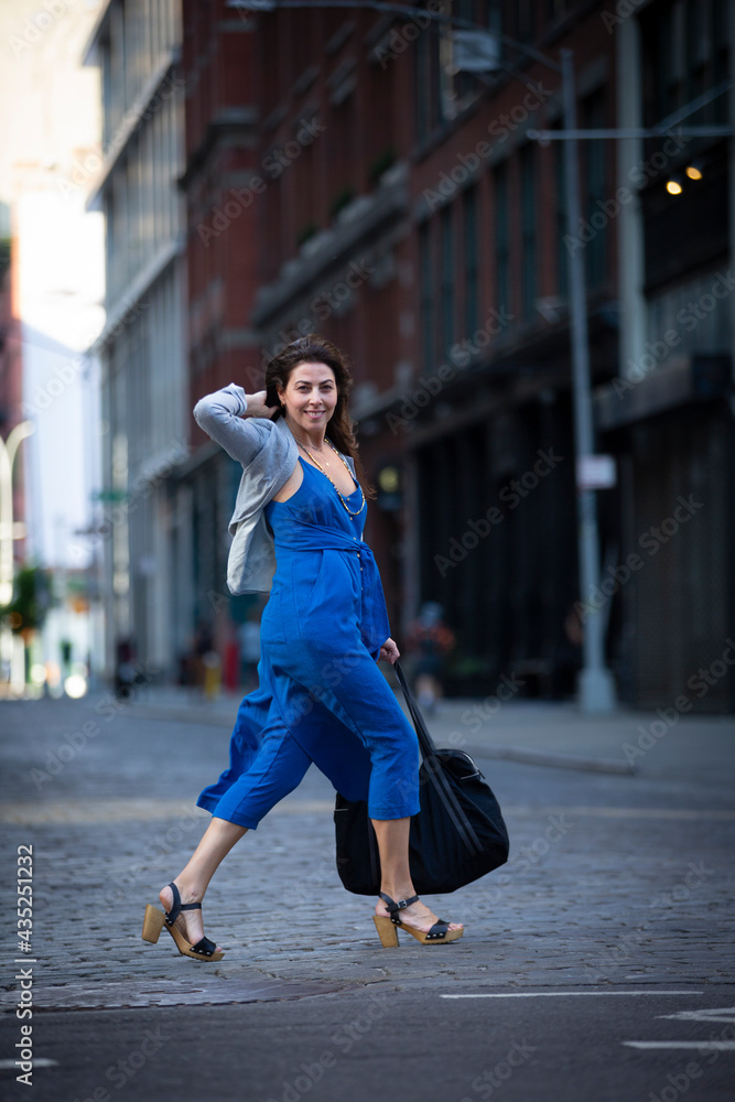 urban scene of a young woman on a blue dress downtown New York