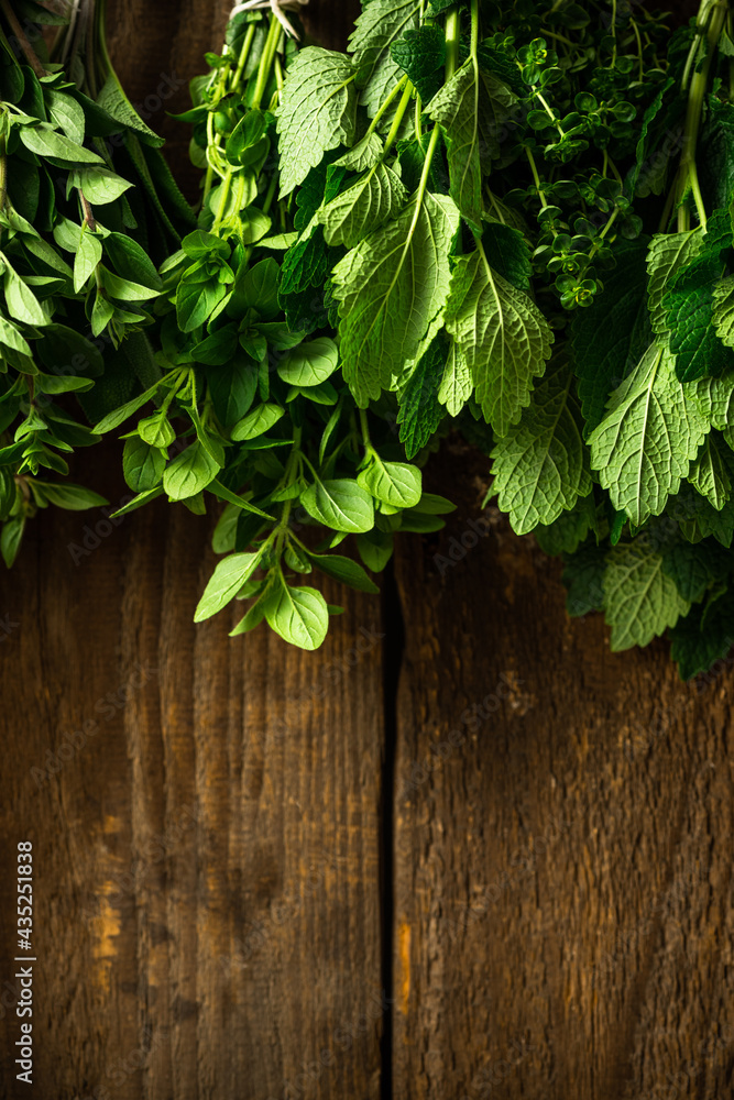 Hanging Bunches of Drying Aromatic Herbs and Spices. Wooden Background. Copy Space. Hanging Bunches of Drying Aromatic Herbs and Spices. Wooden Background. Copy Space.