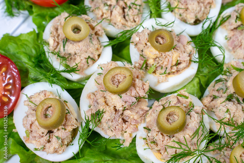 Stuffed eggs with tuna with green vegetables and olives