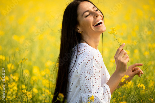 Young woman in the rapeseed field