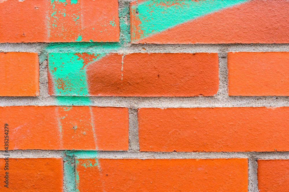 Graffiti on a red brick wall. Close-up view - obrazy, fototapety, plakaty 