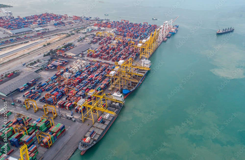 Aerial view panoramic for moving pass sea port warehouse and container ship or crane ship working for delivery containers shipment.