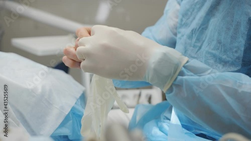 Close-up of a male surgeon wearing sterile gloves