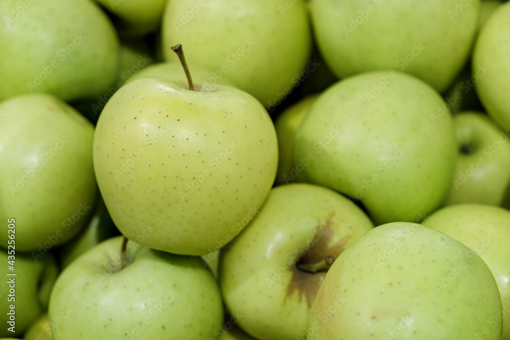 Yellow apples of the Golden Delicious variety on counter of farmers market. Fruits are large, with yellowish-green skin, and have sweet taste. Natural products, seasonal fruits, local food. Yellow apples of the Golden Delicious variety on counter of farmers market. Fruits are large, with yellowish-green skin, and have sweet taste. Natural products, seasonal fruits, local food.