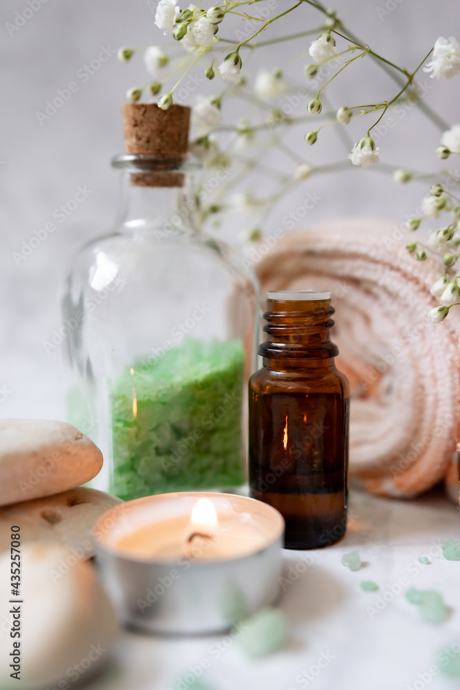 set of spa cosmetics: sea salt, essential oil, towel and aroma candle. vegan products, natural ingredients set of spa cosmetics: sea salt, essential oil, towel and aroma candle. vegan products, natural ingredients