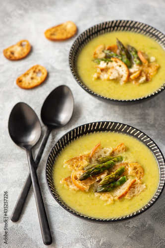 Homemade asparagus cream soup with croutons.