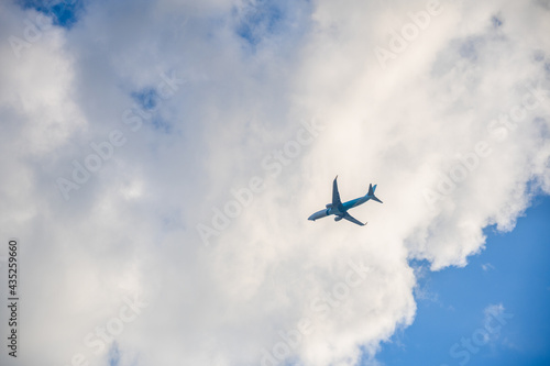 Airplane in the blue sky and clouds.