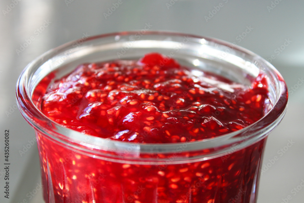 Fresh jam in a glass jar. Close-up. Top side view. Background. Fresh jam in a glass jar. Close-up. Top side view. Background.