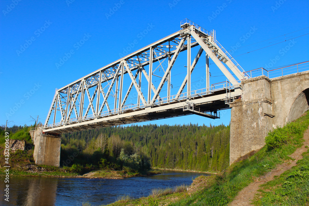 Large old metal railway bridge over the river. Close-up. Background. Scenery.