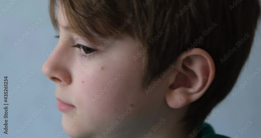 Cute teenage boy turns and looks at the camera. Portrait of a young handsome guy. A look at the camera Cute teenage boy turns and looks at the camera. Portrait of a young handsome guy. A look at the camera