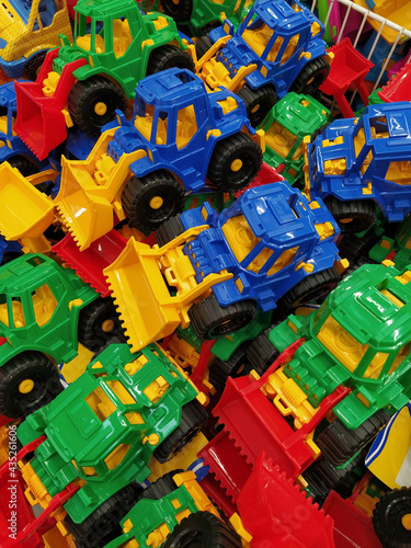 Many colored toy bulldozers in the store.
