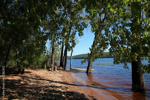 View of Afton State Park Shoreline with turned over boat at shoreline partially in the St. Croix River.