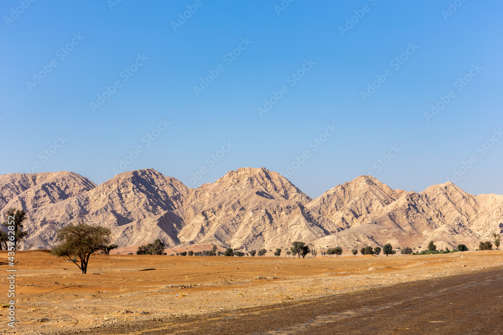 Jebel Al Fayah rocky mountain range in the desert in Sharjah, United Arab Emirates.